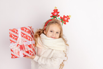 baby girl holding red gift on white isolated background, space for text