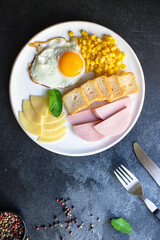 breakfast fried egg, bread toast, vegetables, corn, cheese and more on the table serving healthy meal snack ingredient top view copy space for text food background rustic