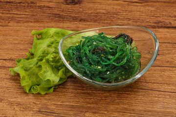 Green Chuka Seaweed Salad Isolated on White Background Top View. Wakame Sea Kelp Salat
