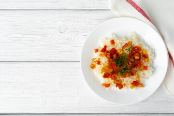 Prepared rice with vegetables on white wooden table