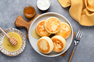 Tasty cottage cheese fritters Syrniki served with honey. Top view. Russian, ukrainian cuisine food