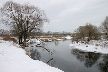 Photo the snow-covered river did not freeze in winter.The river flows in winter. Snow on the...