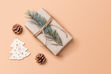 Christmas and zero waste, eco friendly gift wrapping in kraft paper on on beige table, ecological christmas holiday concept with eco decor. Top view with copy space.