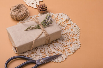 Christmas and zero waste, eco friendly gift wrapping in kraft paper on on beige table, ecological christmas holiday concept with eco decor.