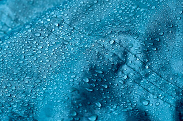 Rain water droplets on waterproof fabric.