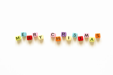 Words "merry christmas" with colorful  iblocks solated on a white background