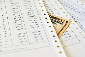 Ten dollar on a pile of papers with loss numbers.