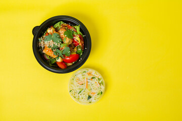 Fast food Chinese, chicken vegetable salad. On yellow background