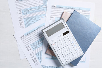 Naklejka na ściany i meble Calculator, notebooks and documents on white table, flat lay. Tax accounting