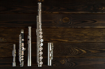 flute parts laid out on a wooden surface © viktor