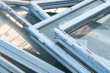 Old White wooden window frames with broken glass Closeup high angle view