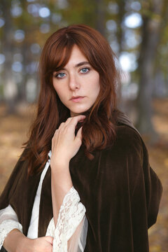 Portrait of a beautiful girl with brown cloak