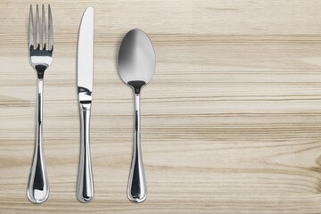 Silverware. Fork, spoon and knife on the desk