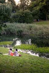 people resting near lake at city public park