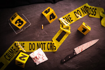 Flat lay composition with evidences and crime scene markers on black background