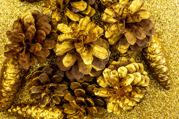  Christmas decorations with Pine Cone fortuna gold color as texture background. Hight quality photo