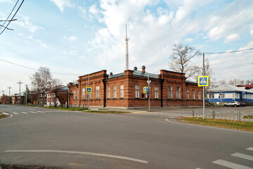 Fototapeta na wymiar The historical brick building of Balandin's reading room, now the registry office in the city of Yeniseysk, Krasnoyarsk region of Russia. View from Lenin Street.