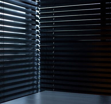 Wood blinds Coulisse black color closeup on the window in the interior. Wooden slats 50mm wide, black tapes. Venetian blinds closed in the room.