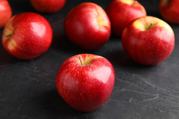 Fototapeta na wymiar Fresh ripe red apples on black table, closeup