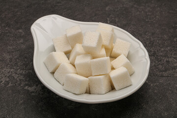 Refined white sugar cubs in the bowl