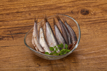 Anchovies in the bowl served basil leaves