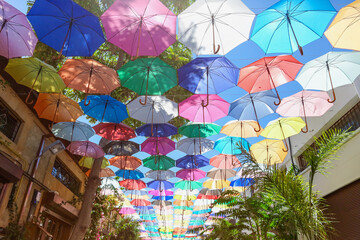 Fototapeta na wymiar Colorful umbrellas street decoration on shopping alley in Nicosia, Northern Cyprus. Sunny day. Travel concept
