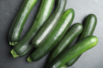 Green ripe zucchinis on black slate table, flat lay