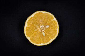 Fototapeta na wymiar slice of lemon on black background