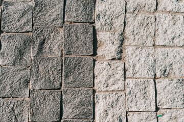 Texture of gray stone paving stones in close-up