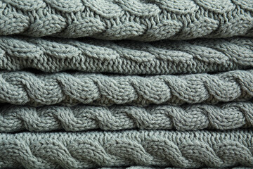 Soft knitted plaid as background, closeup view