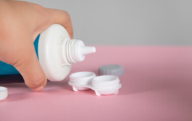 woman holding water for lenses
