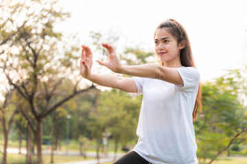 young women has an stretching exercises outdoors at park