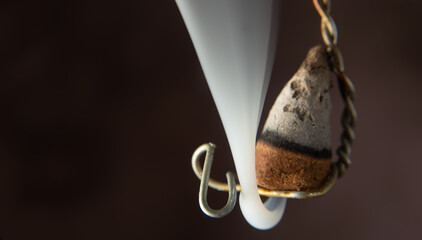 Burning incense hanging on an old wire, selective focus.