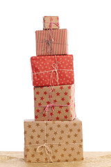 Stack of christmas gifts on golden underground with white background