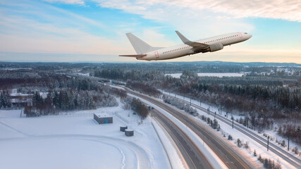 A passenger plane landing at Oslo Gardermoen International Airport - Airport in a snow covered -...