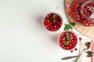 Tasty hot cranberry tea and fresh ingredients on light table, flat lay. Space for text
