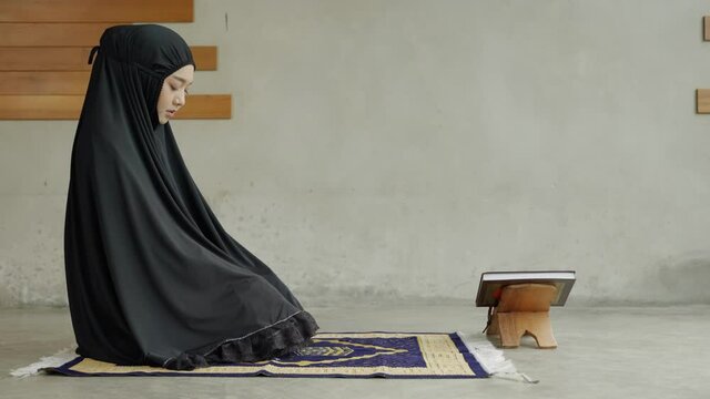Side view video of Two young Muslim women are performing prayers. Islamic religion,part 2
