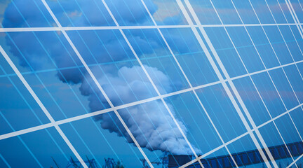 Clean and dirty energy concept - Renewable solar panel energy with  Chimneys of thermal power plant...