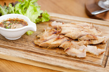 Charcoal-boiled Pork Neck with the Sauce is Spicy Sour Taste is a Popular Appetizer in Thailand. Grilled pork steak thai food