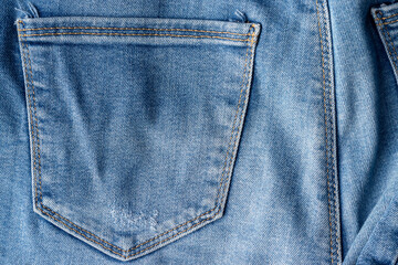 Blue jeans fabric texture. Distressed denim with back pocket background