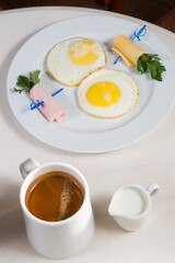 Fried eggs with cheese and bacon