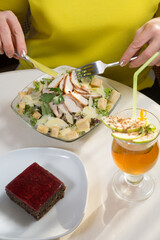 Woman eating salad at cafe