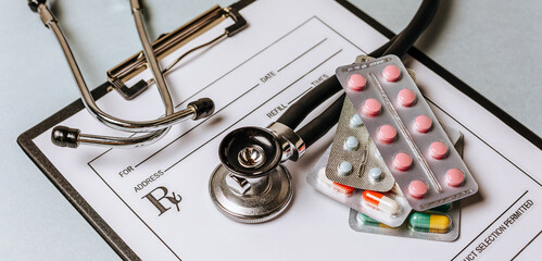 Medical concept flat lay with stethoscope, pills, notepad on the doctor desktop