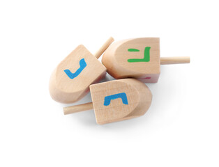 Wooden Hanukkah traditional dreidels on white background, top view