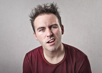 young man looks in the room trying to understand something