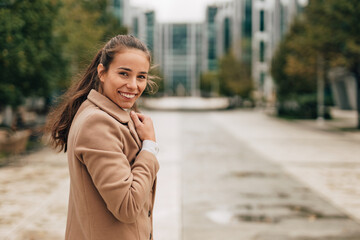 Fototapeta premium Smiling at camera, wearing new autumn fashion outfit.