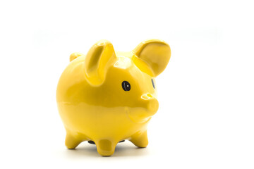 Closeup of yellow piggy bank on white background