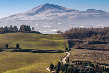 Beautiful panoramic view of Monte Amiata covered with snow from Monticchiello, Siena, Tuscany, Italy
