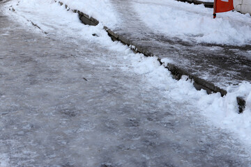 Uncleaned from snow, icy sidewalk.
