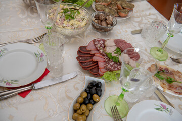  Dinner table served with cold cuts, olivier, balyk, salads and vegetables